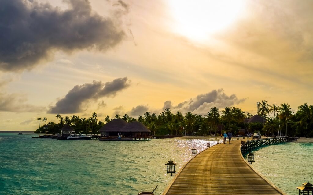 maldives-tropical-sea-palm-trees-boats-bridge-houses-2K-wallpaper